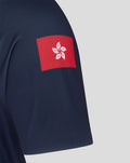 Close up of navy jersey hem showing Castore authentic product patch with wings emblem