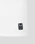 White jersey sleeve with a small black Castore authentic product badge