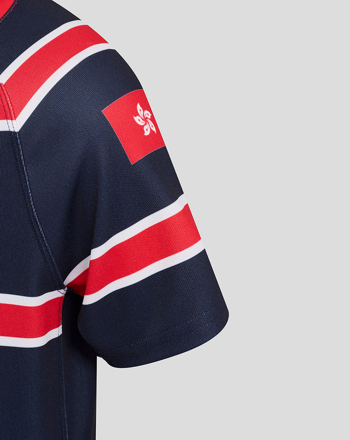 Close up of navy junior HKCR Home jersey sleeve with red white stripes and a red patch featuring a white emblem.