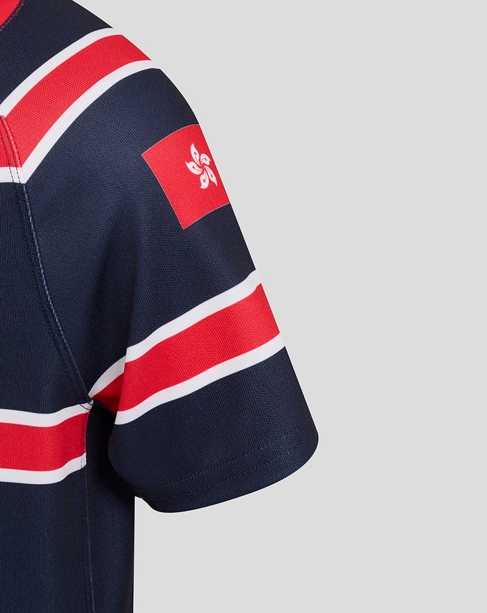 Close up of navy junior HKCR Home jersey sleeve with red white stripes and a red patch featuring a white emblem.