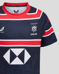 Front chest view of navy HKCR Home 15s jersey with crest on the chest and a large geometric sponsor diamond across the front and red collar.
