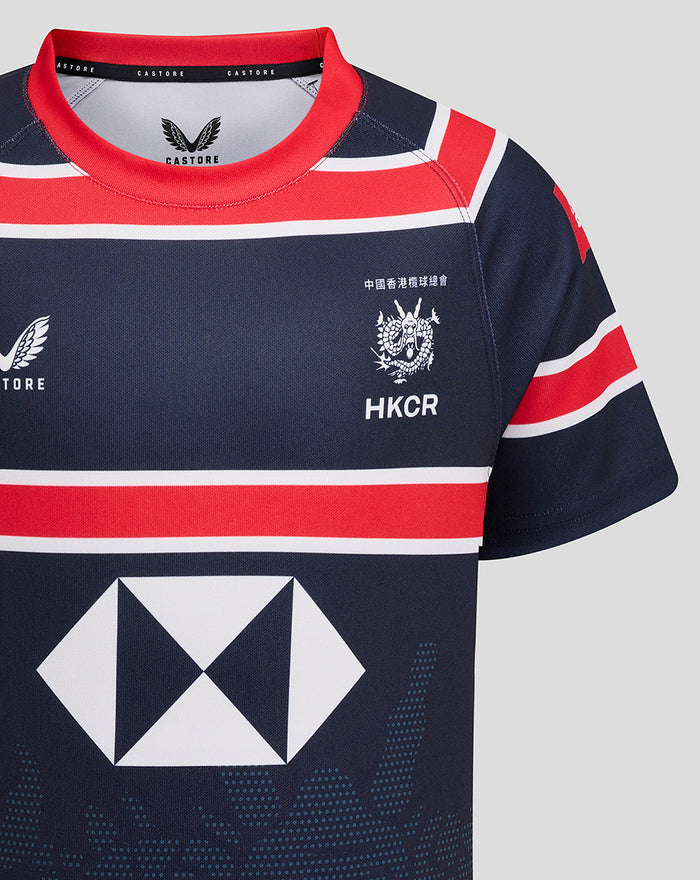 Front chest view of navy HKCR Home 15s jersey with crest on the chest and a large geometric sponsor diamond across the front and red collar.