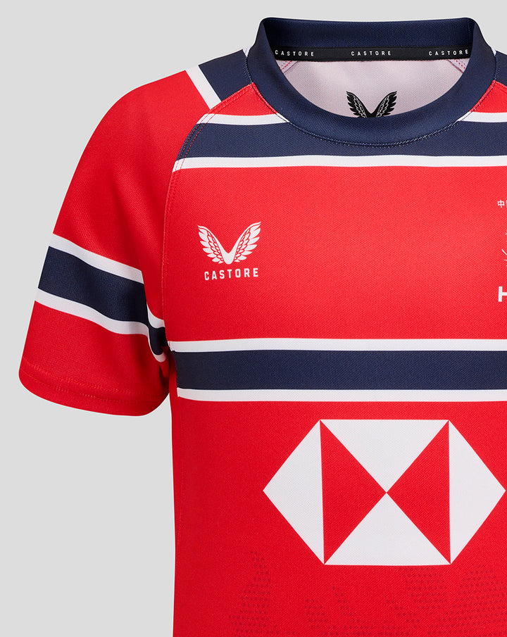Close-up of shoulder and neckline of red HKCR away jersey with Castore branding and navy trim