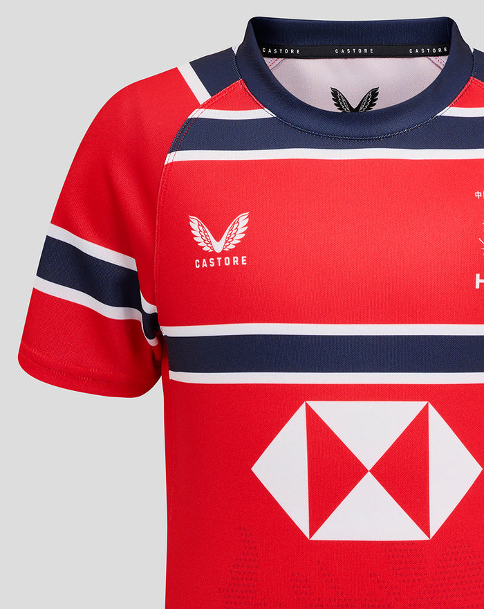 Close-up of shoulder and neckline of red HKCR away jersey with Castore branding and navy trim