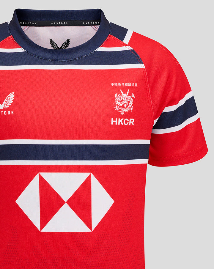 Front close up of HKCR Away jersey on red fabric with navy white stripes, crest HKCR and large diamond sponsor logo
