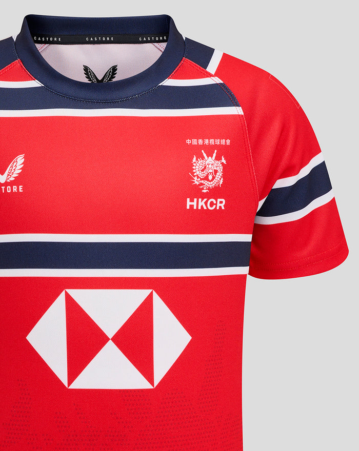 Front close up of HKCR Away jersey on red fabric with navy white stripes, crest HKCR and large diamond sponsor logo