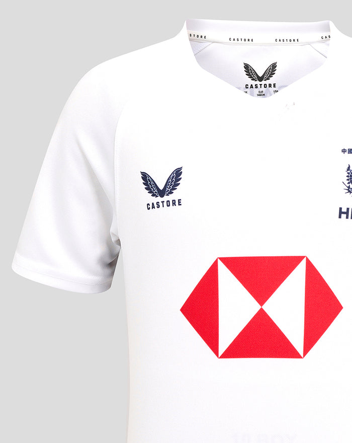 Close-up of the collar area on the white junior away jersey showing Castore branding and detailing at the neckline.