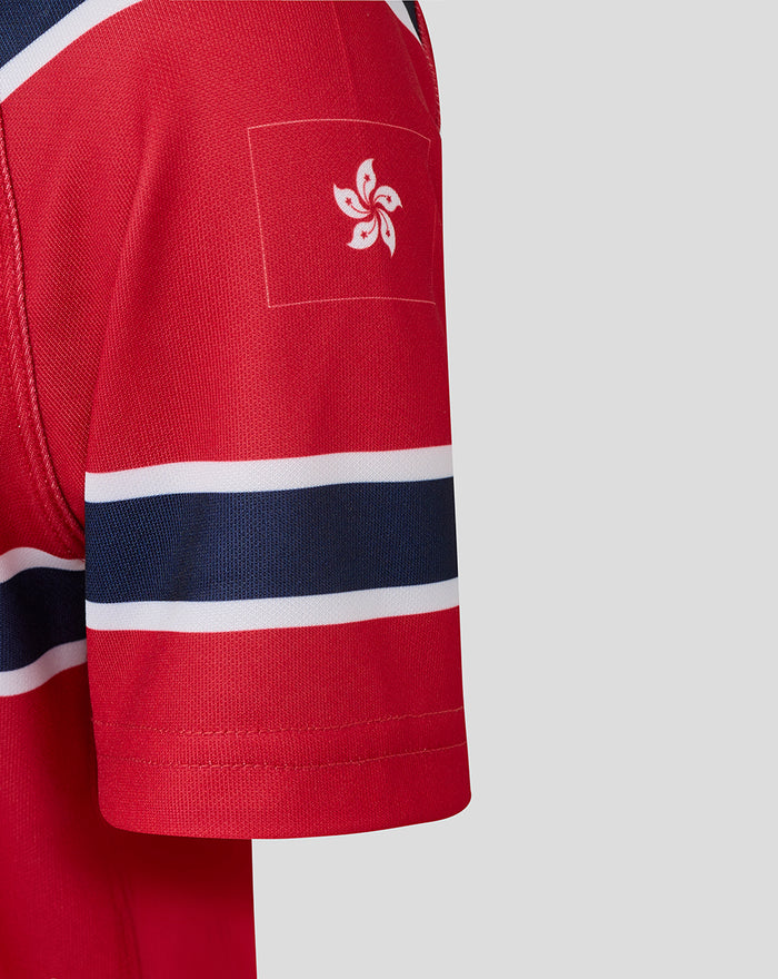 Red HKCR jersey sleeve featuring a white square patch with a stylized four petal floral emblem.