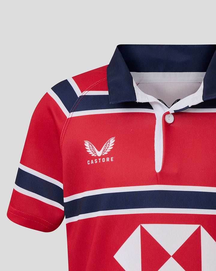 Red and navy HKCR away jersey close up showing Castore wing logo and bold chest stripes.