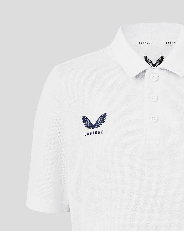 Close up of white junior HKCR graphic training polo with navy wing crest on the chest and Castore branding at the collar.