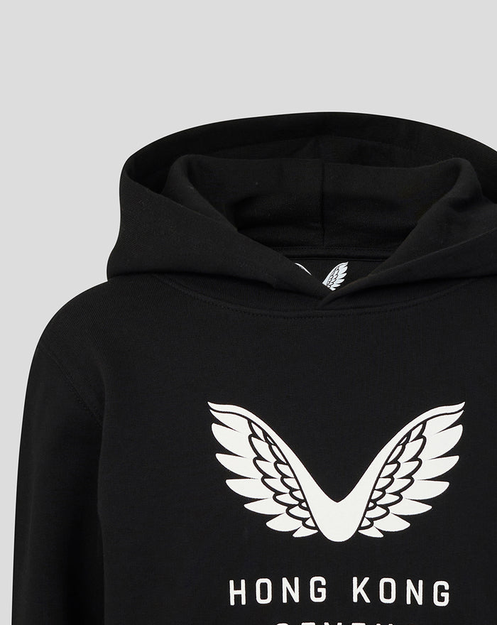 Close-up of the white wings logo on the chest of a black Junior HK7s Hoodie
