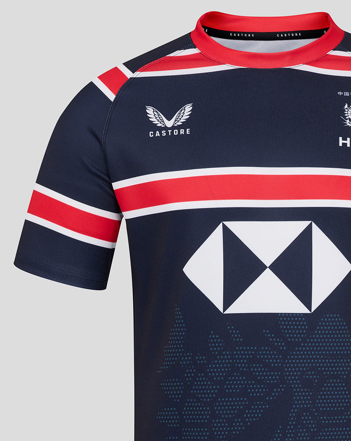 Close up of navy jersey showing Castore logo on left chest HKCR crest on right chest and the large diamond sponsor across the torso.