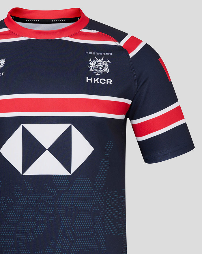 Front close up of navy HKCR jersey with crest on left chest red collar trim and large sponsor diamond across the front.