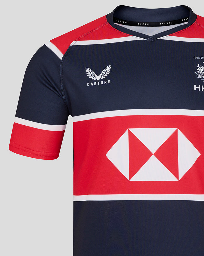 Front view of navy HK 7s replica jersey featuring CASTORE logo left chest HKCR crest and a red sponsor panel.