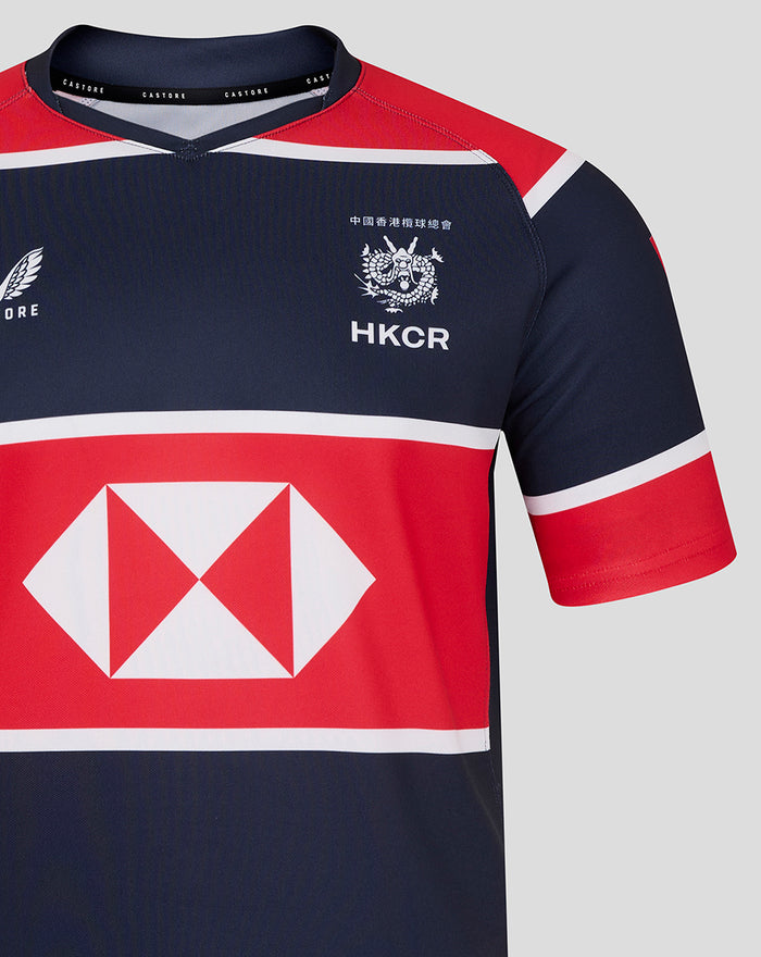 Close up of navy HK 7s replica jersey chest showing HKCR crest and a large red sponsor band.
