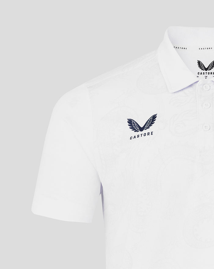 Close up of the white polo front showing the Castore logo on the chest and the HKCR crest on the opposite side.