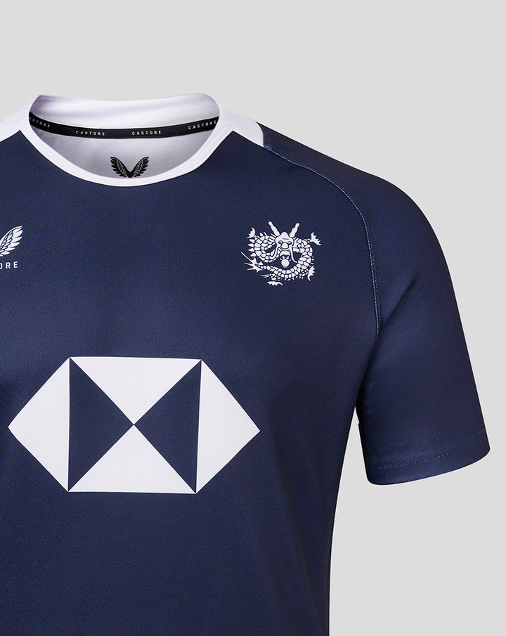 Navy home replica jersey with white crew neck, large white diamond sponsor logo across the front and a small club crest on the chest.