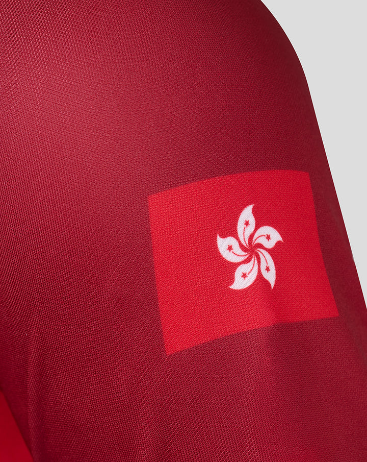 Close-up of red sleeve with a white Hong Kong bauhinia emblem patch