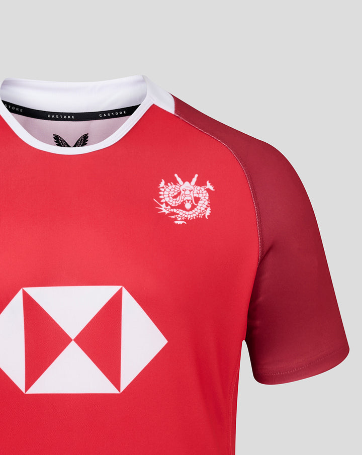 Red away replica jersey close up showing a white chest crest and bold white diamond sponsor