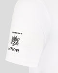 Close up of sleeve showing HKCR logo and dragon emblem on white rugby tee.